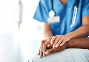 health-care-worker-holding-patient's-hand-image